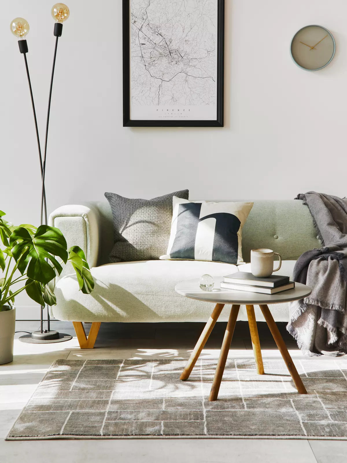 Three children lying on a soft, neutral-toned area rug, surrounded by art supplies and drawings, creating a cozy and playful living space.