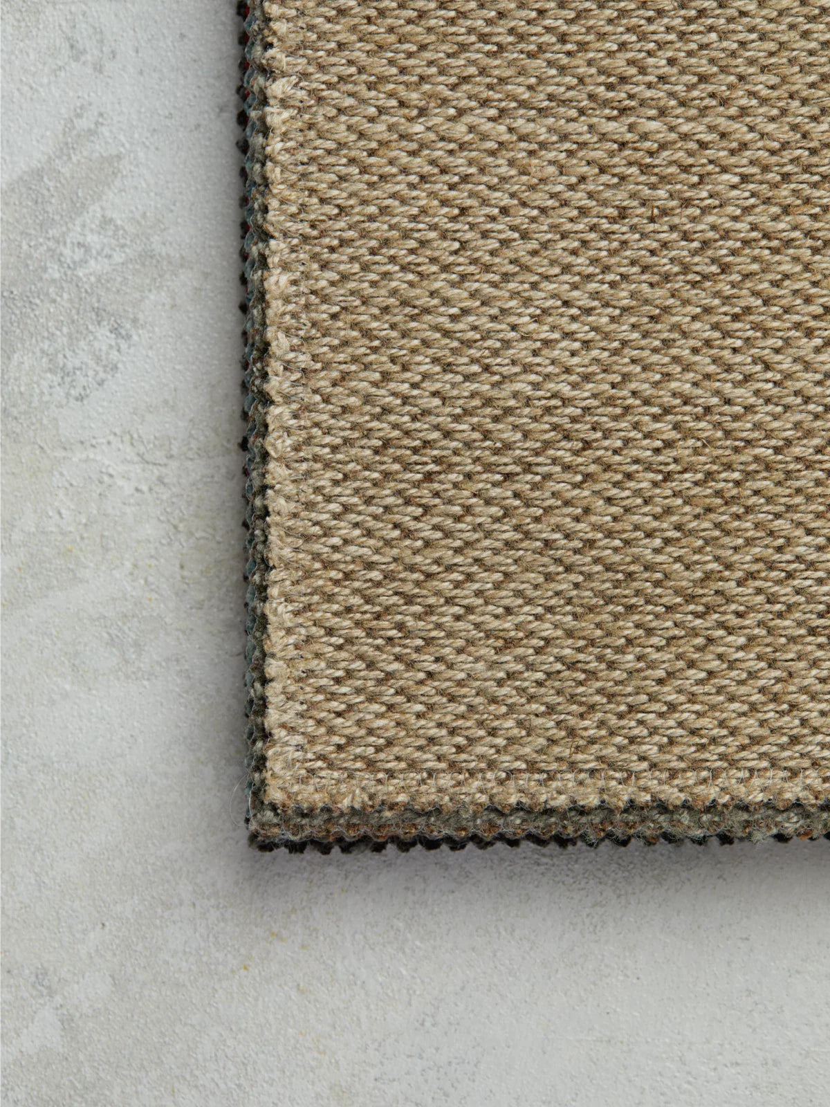 Close-up of a woven jute runner rug, showcasing its natural texture and intricate handwoven fibers, ideal for hallways and high-traffic areas.