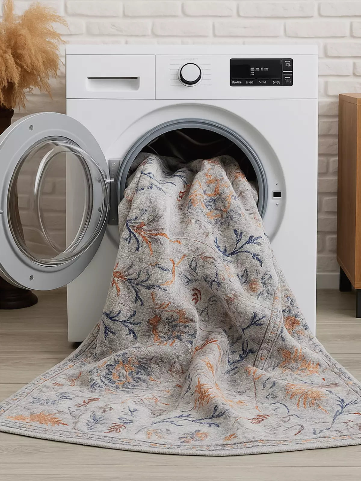 A close-up of spilled coffee from a white mug on a light-colored rug with black geometric lines.