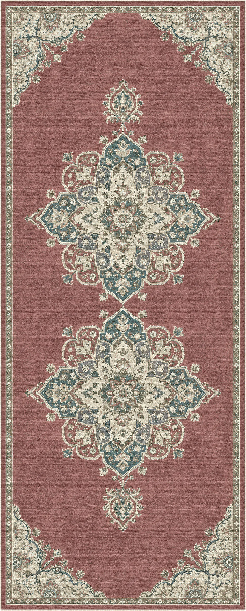 Un tappeto rettangolare con un motivo tradizionale a medaglione nei colori rosa antico, blu petrolio e crema, disposto piatto su uno sfondo bianco.
