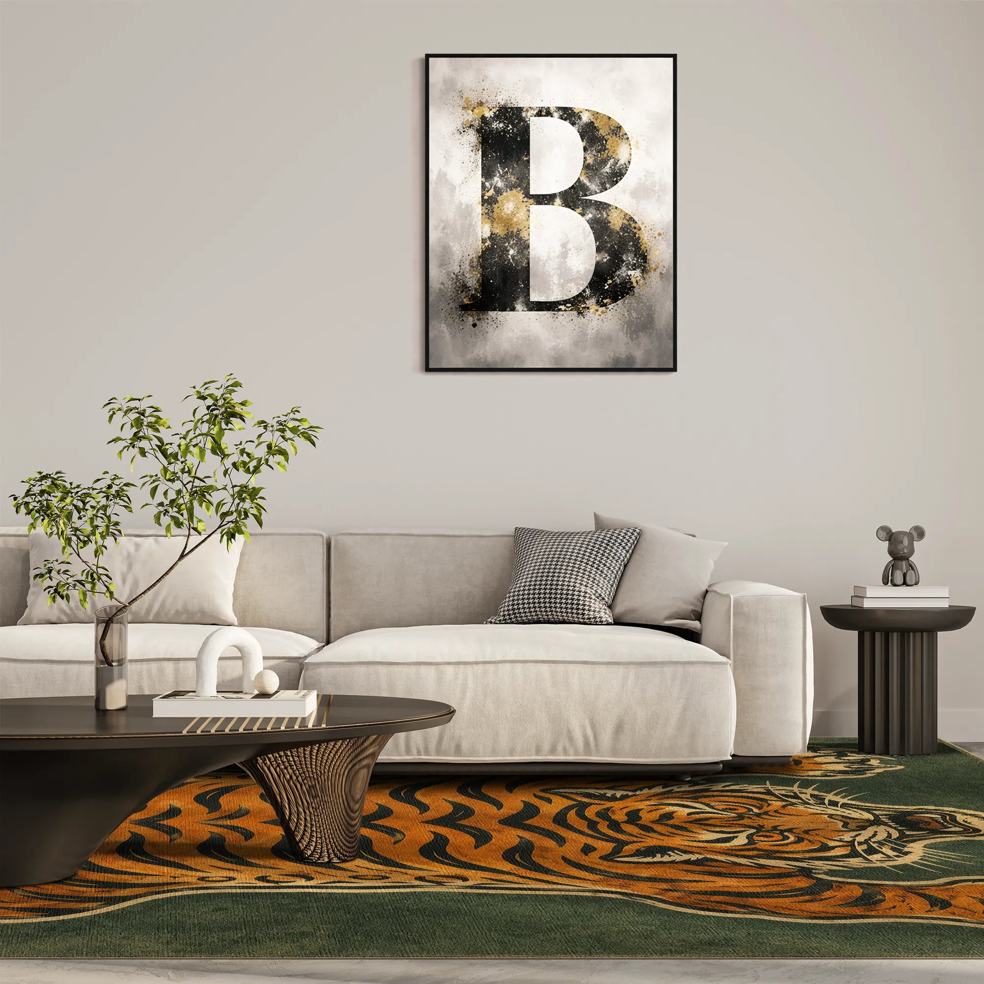 A tiger rug with a modern living room setting featuring a square framed wall art print with a textured black and gold letter 'B' on a gray and white background, hung above a light beige sofa.